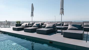 Seasonal outdoor pool, pool umbrellas, pool loungers