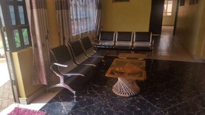 A seating area with a sofa and chairs, a coffee table, and a patterned rug.