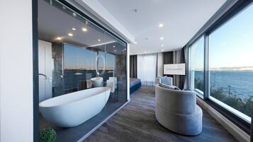 A modern bathroom with a large freestanding bathtub, a glass-enclosed shower area, and a view of the city through large windows.