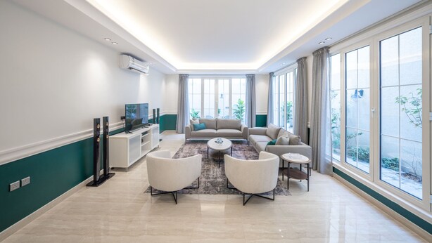 A modern living room with a sofa set, coffee table, and TV. - Mabaat - Al Yasmeen - 353 (Riyadh)