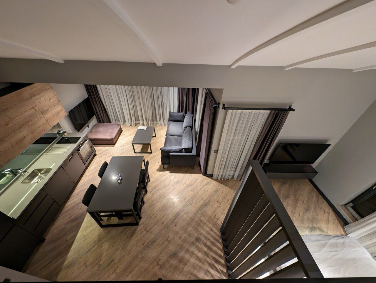 A modern apartment with a kitchen, dining area, and living space.