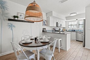 Enjoy cooking in this well-equipped kitchen with a central island, microwave, and stainless steel sink.