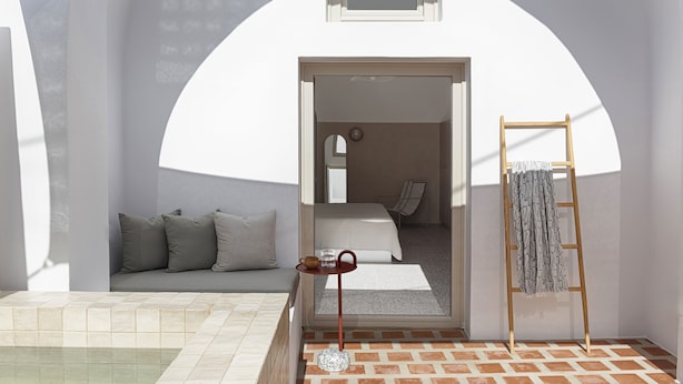 A modern, minimalist bedroom with a bed, a small table with a cup and glass, and a ladder against the wall. - Ethos Vegan Suites (Santorini)