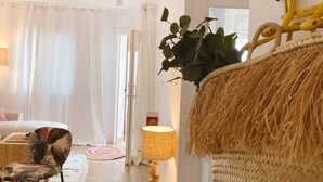 A room with a bed, a chair, a lamp, and a plant. - SibsSanlucar- Maritimo-1ª beach line- cozy- terrace (Sanlúcar de Barrameda)