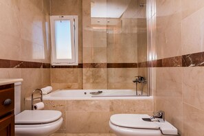 Bathtub, hair dryer, towels, soap