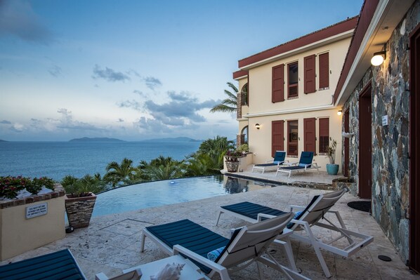 Outdoor pool, an infinity pool, pool loungers