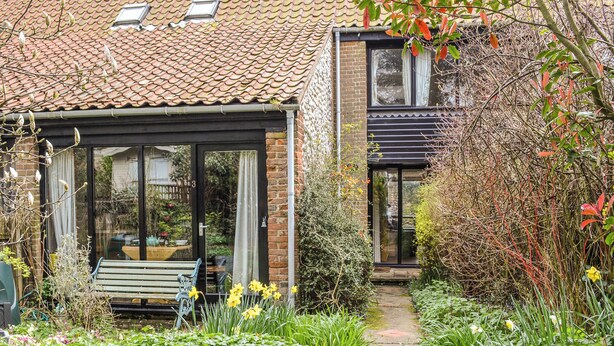 A house with a conservatory, a garden path, and a bench. - A lovely traditional Norfolk barn conversion in the heart of the coastline. (Sidestrand, near Cromer)