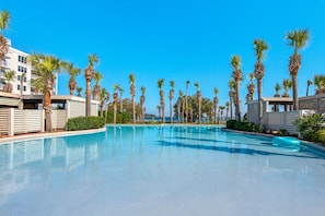 A swimming pool with palm trees and modern buildings in the background. - Snowbird Special Jan Feb!Walk2Beach~Views~1BR+Bunk Destin West Gulfside 203 (Fort Walton Beach)