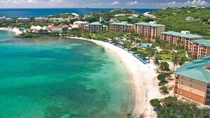 A coastal resort with beachfront villas, a sandy beach, and a view of the ocean. - Luxurious 2 bedroom, 2 bath Oceanfront Condo @ the Ritz Carlton Club (St Thomas)