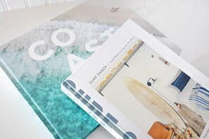 A book titled 'COAST' with a surfboard image on the cover.