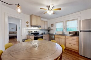Enjoy cooking in this well-equipped kitchen with a central island, stainless steel appliances, and ample natural light.