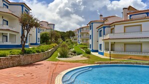A resort with a swimming pool, multiple-story buildings, and well-maintained gardens. - Praia Del Rey - Beach/Pool/Golf/Adventure (Amoreira)