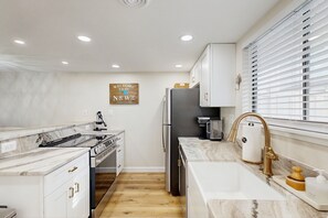 Fridge, microwave, oven, stovetop - Updated coastal getaway with pool - walk to beach, dining, shops & entertainment (Ocean City)