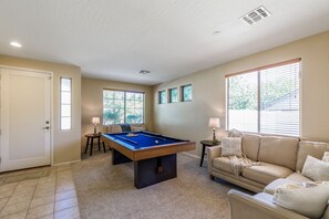 Relax in this spacious room with a pool table and comfortable seating area.