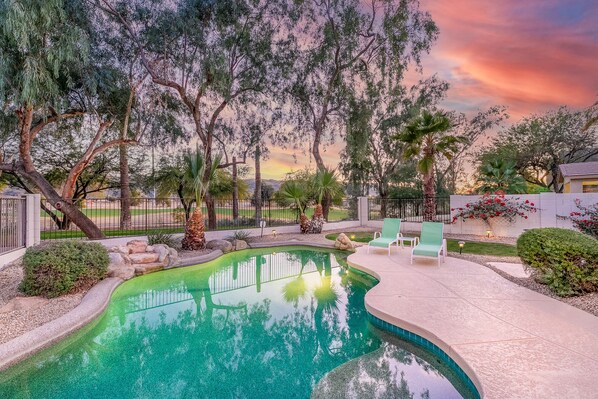 Relax by the serene pool surrounded by lush trees and lounge in style.