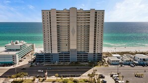 A high-rise hotel with multiple floors, a parking garage, and a beach view. - Beautiful Beachfront Condo with Amazing Views and Beachfront Pool! Chair Service Included* (Panama City Beach)