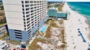 A high-rise hotel with multiple balconies overlooking a beach. - Beautiful Beachfront Condo with Amazing Views and Beachfront Pool! Chair Service Included* (Panama City Beach)