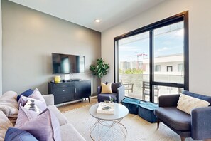 Relax in this stylish living room with a city view, flat-screen TV, and comfortable sofa.