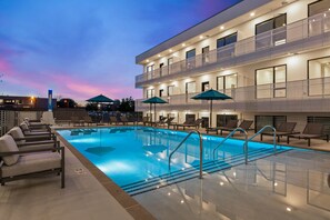 Relax by the pool surrounded by lounge chairs and umbrellas, or enjoy the outdoors from one of the many balconies with seating areas.