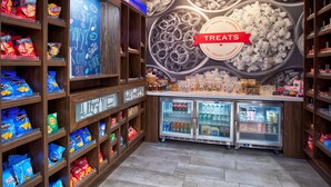 A snack display with various chips and a 'TREATS' sign. - Hampton Inn By Hilton Paris (Paris)