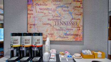 A coffee station with three coffee dispensers labeled 'Light Roast,' 'Decaf Roast,' and 'Hot Water.'