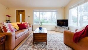 A living room with a sofa, coffee table, and TV.