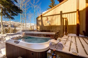 Relax in the hot tub surrounded by serene natural beauty and a tranquil atmosphere.