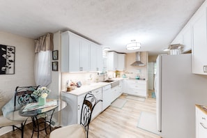 Enjoy cooking in this well-lit kitchen with a central island and sink.