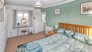 Une chambre à coucher avec un lit, un bureau et une chaise.