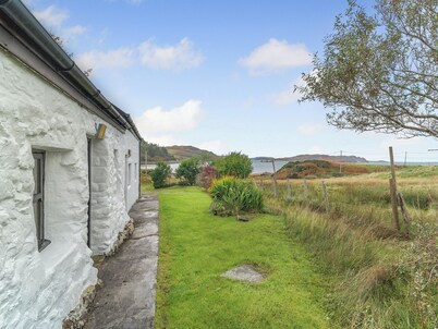 A tiny, traditional cottage tucked away on the Ross of Mull, close to the sea.