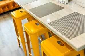 Enjoy meals in a stylish dining area with a rectangular table and comfortable seating for four.
