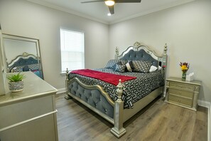 Restful retreat with a large bed, bedside table, and mirror.