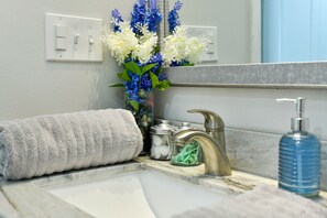 Bathroom features a sink, mirror, and bathtub.