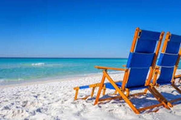 Relax in a beachside haven with a comfortable chair on the sandy shore.