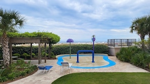 Relax by the pool surrounded by a lush lawn and a pergola.