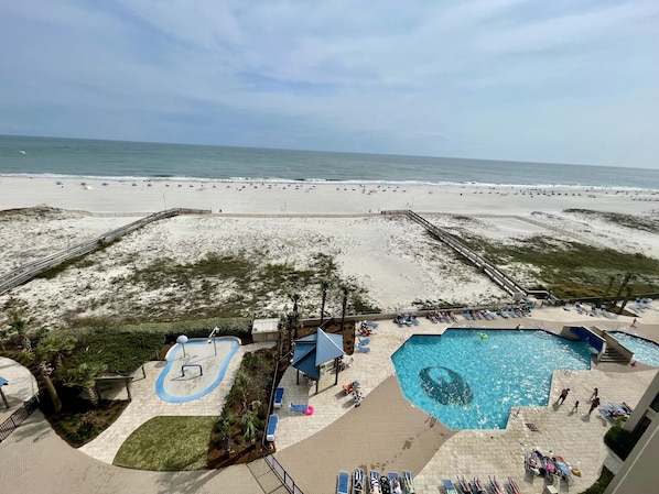 Enjoy ocean views from this beachfront hotel, featuring a pool area with multiple pools and sun loungers, a sandy beach, and a children's play area with a slide.