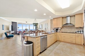 Enjoy cooking in this well-equipped kitchen with a central island, dishwasher, and ample counter space.