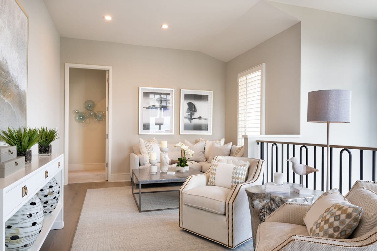 A modern living room with a sofa set, a coffee table, and decorative items.
