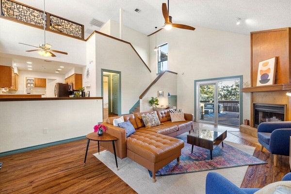 Mid century modern vibes in a warm and spacious home. All that natural light makes this space feel light bright and open.