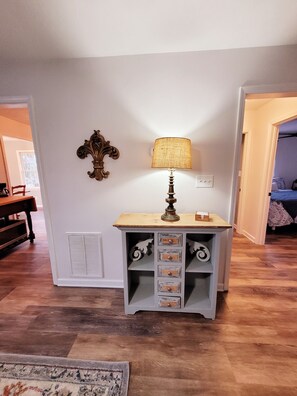 A room with a wooden table, a lamp, and a decorative wall piece. - CHARMING COTTAGE LESS THAN 5 MILES TO DOWNTOWN BLUE RIDGE (Blue Ridge)