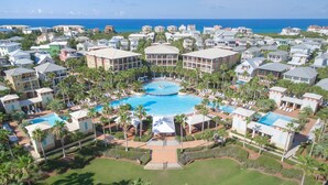 A resort with multiple swimming pools, palm trees, and ocean views. - Perfect home for multiple families with beach tram service and a huge pool. (Inlet Beach, FL)