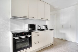 Enjoy cooking in this well-equipped kitchen with a Bosch microwave, Siemens oven, and coffee maker.