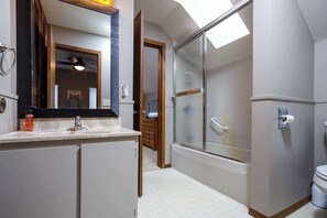 A bathroom with a mirror, sink, toilet, and a glass-enclosed shower. - 185' Waterfront Sand Bay Owl's Nest 4BR sleeps 9 (Sturgeon Bay)