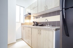 Executive Room | Private kitchen | Fridge, toaster, blender, dining tables