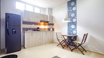 Executive Quadruple Room | Private kitchen | Fridge, toaster, blender, dining tables