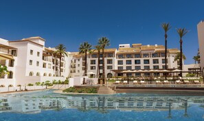 A hotel with multiple floors, a swimming pool, and palm trees. - La Zambra Resort Mijas - Marbella The Unbound Collection By Hyatt (Mijas)