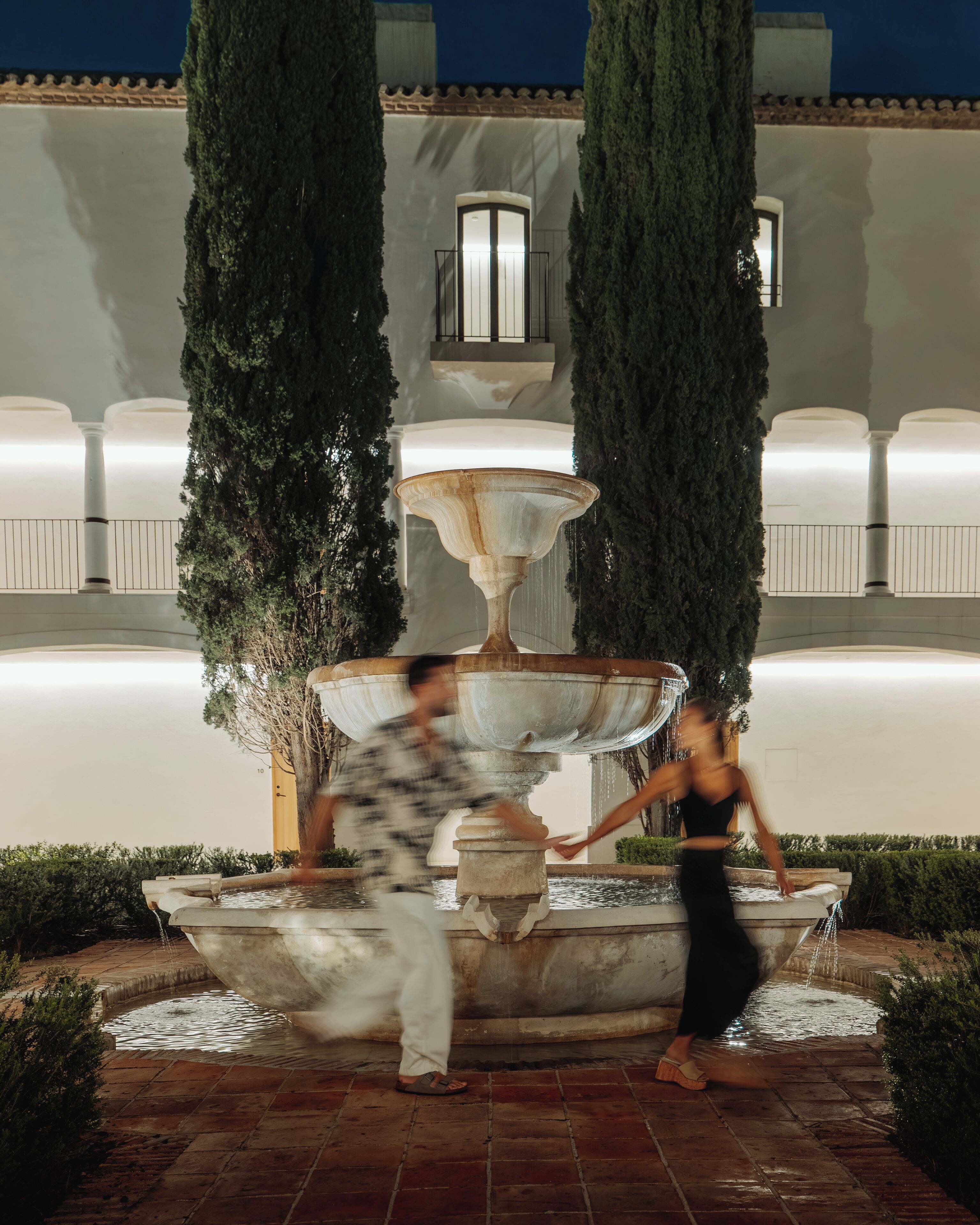 A fountain with multiple tiers and water flowing from the top tier.