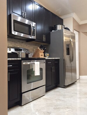 Microwave, dishwasher, coffee/tea maker, cookware/dishes/utensils