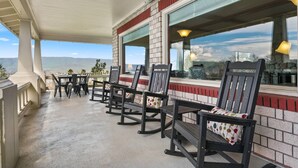 A covered outdoor seating area with a view of the landscape. - Expansive Panoramic View of Columbia Gorge, Enormous Deck and Seating, BBQ, Billiards, Darts, Games (The Dalles)