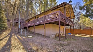 A cabin with a wooden deck, a satellite dish, and a picnic table. - Patio, Grill + Mogollon Rim Views: Payson Cabin (Payson)